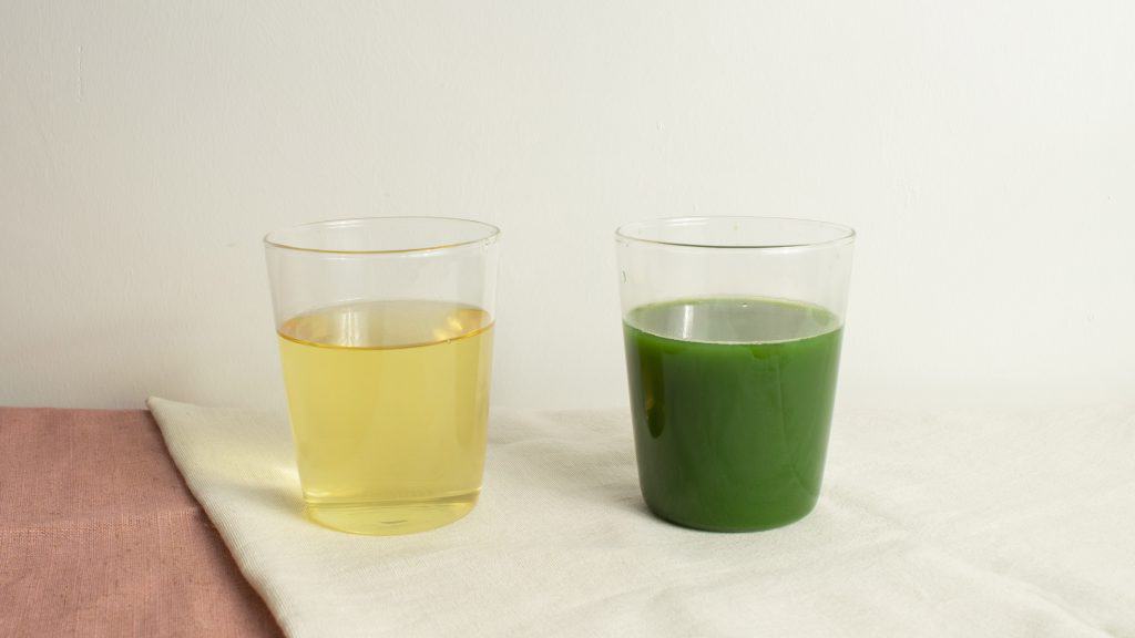 Two glasses of tea, pale yellow on the left and bright green on the right