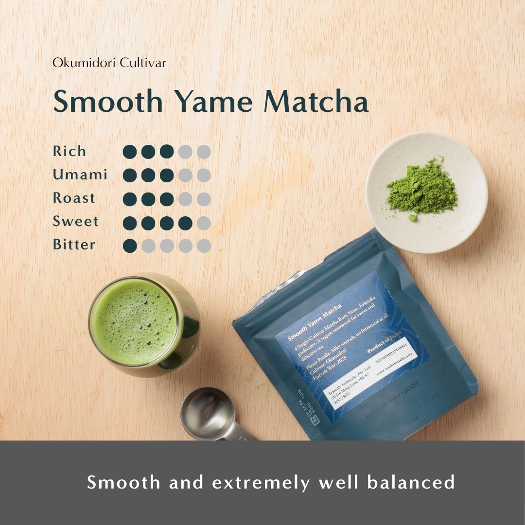 Flat lay of Okumidori Cultivar Smooth Yame Matcha showing a cup of prepared matcha, a small dish of powder, and the blue package on a light wood surface